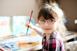 Photo: Cute little girl painting Cute little girl painting