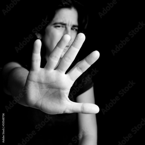 Photo: Frightened woman with her hand extended for protection Frightened woman with her hand extended for protection