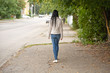 girl goes on city street in the autumn afternoon