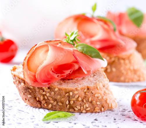 Photo: Jamon. Slices of Bread with Spanish Serrano Ham Served as Tapas Jamon. Slices of Bread with Spanish Serrano Ham Served as Tapas