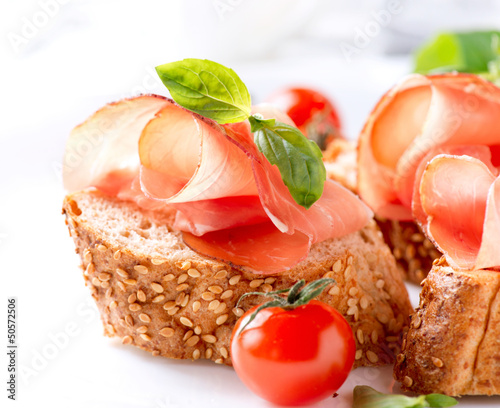 Photo: Jamon. Slices of Bread with Spanish Serrano Ham Served as Tapas Jamon. Slices of Bread with Spanish Serrano Ham Served as Tapas