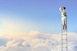 Businesswoman standing on ladder