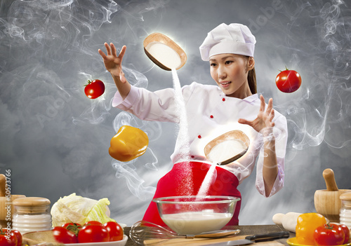 Photo: Asian female cooking with magic Asian female cooking with magic