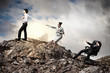 Three business people pulling rope