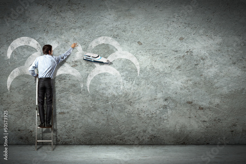 Photo: Business man on ladder Business man on ladder