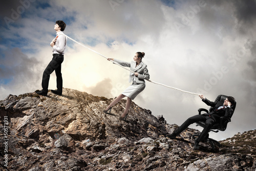 Photo: Three business people pulling rope Three business people pulling rope