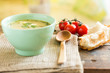 bowl of soup on a vintage table an a wooden spoon