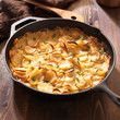 scalloped potatoes in rustic iron skillet
