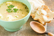bowl of soup on a vintage table an a wooden spoon