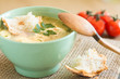 bowl of soup on a vintage table an a wooden spoon