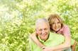 happy senior man giving piggyback ride