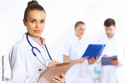 Photo: Young female doctor in white uniform Young female doctor in white uniform