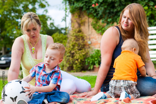 Photo: Mother and grandmother with children in a park Mother and grandmother with children in a park