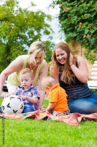 Photo: Mother and grandmother with children in a park Mother and grandmother with children in a park