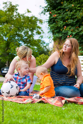 Photo: Mother and grandmother with children in a park Mother and grandmother with children in a park
