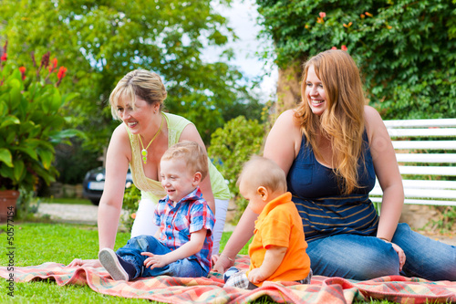 Photo: Mother and grandmother with children in a park Mother and grandmother with children in a park