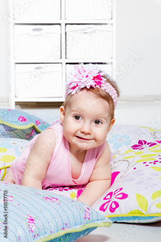 Photo: Lovely baby girl lying on the pillows Lovely baby girl lying on the pillows