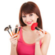 Young woman with brushes for makeup isolated on white background