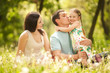 Happy mother, father and daughter in the park