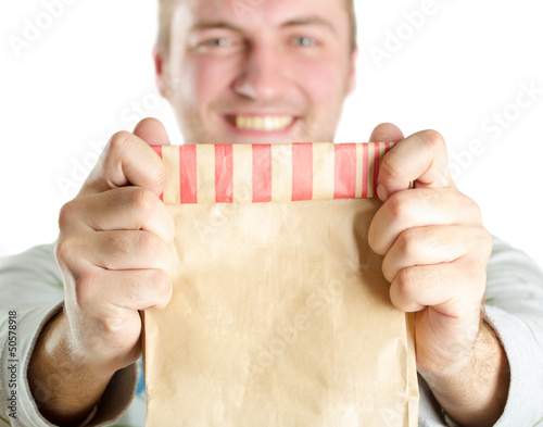 Photo: Man holding paper bag Man holding paper bag