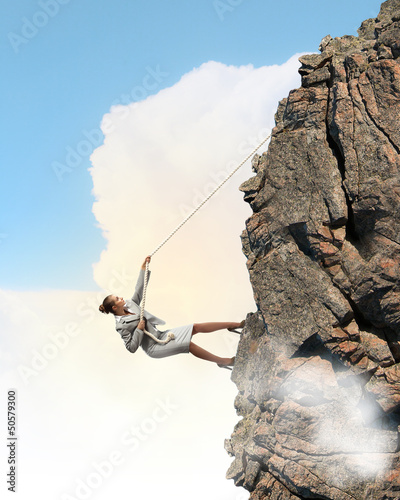 Photo: businesswoman climbing mountain businesswoman climbing mountain
