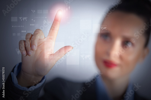 Photo: Business woman touching display Business woman touching display