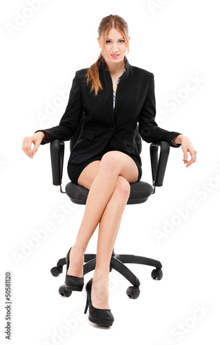 Photo: Businesswoman sitting on a chair isolated on white Businesswoman sitting on a chair isolated on white