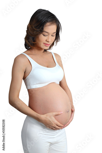 Photo: isolate with path portrait of pregnant woman touching her belly isolate with path portrait of pregnant woman touching her belly