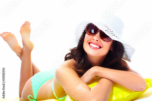 Photo: Woman relaxing on the beach. Woman relaxing on the beach.