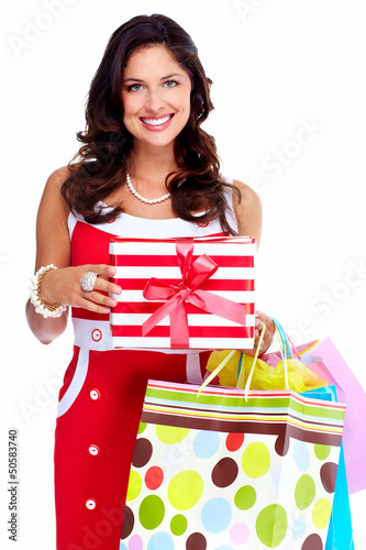 Photo: Beautiful young girl with a Christmas present. Beautiful young girl with a Christmas present.