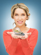 woman showing green light bulb