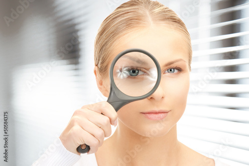 Photo: woman with magnifying glass woman with magnifying glass