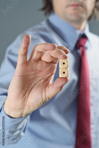 Photo: Businessman holding gambling dices Businessman holding gambling dices