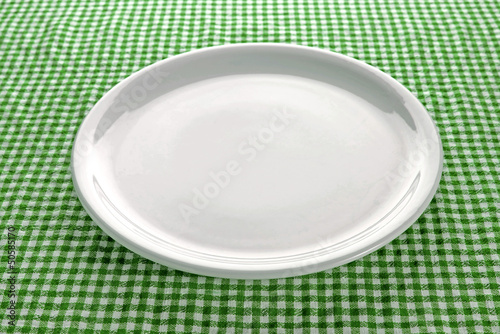 Photo: Empty plate on kitchen table Empty plate on kitchen table