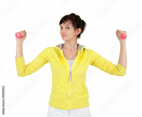 Photo: young woman working out with small dumbbells young woman working out with small dumbbells