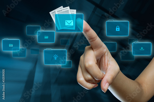 Photo: a woman finger is selecting a folder on a digital screen a woman finger is selecting a folder on a digital screen