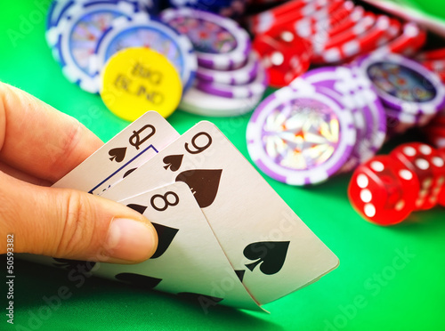 Photo: Card for poker in the hand, chips and card for poker Card for poker in the hand, chips and card for poker