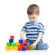 kid boy playing with colorful building blocks or bricks