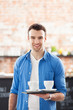 Photo: Waiter holding cups of coffee in cafe Waiter holding cups of coffee in cafe