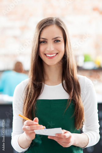 Photo: Portrait of waitress in cafe Portrait of waitress in cafe