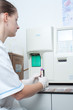 Woman performin hematological test.