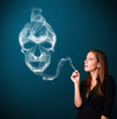 Young woman smoking dangerous cigarette with toxic skull smoke