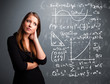 Beautiful school girl thinking about complex mathematical signs