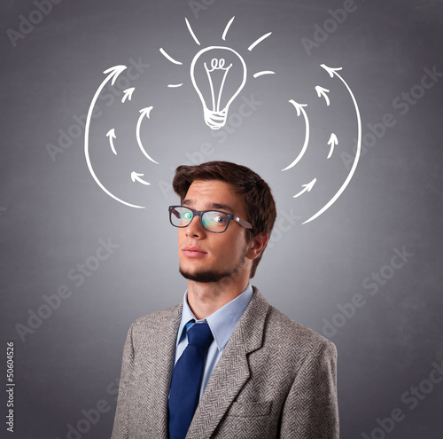 Photo: Young man thinking with arrows and light bulb overhead Young man thinking with arrows and light bulb overhead