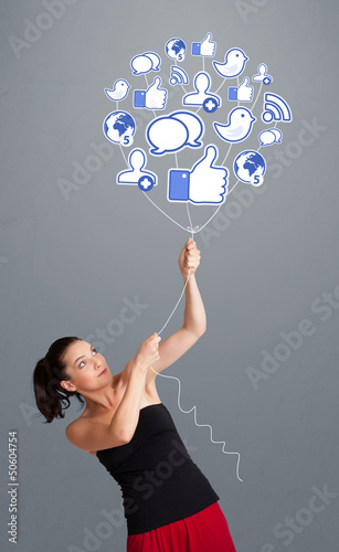 Photo: Pretty woman holding social icon balloon Pretty woman holding social icon balloon