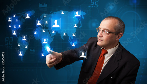 Photo: Businessman choosing from social network map Businessman choosing from social network map