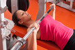 Beautiful smiling young woman exercising in the gym