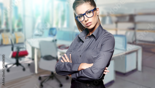 Photo: A portrait of a young business woman in an office A portrait of a young business woman in an office