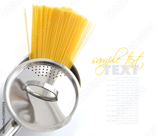 Photo: Pasta spaghetti in pot pan on a white background Pasta spaghetti in pot pan on a white background