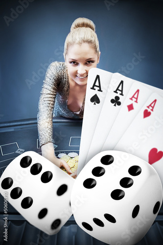 Photo: Blonde woman grabbing chips with digital hand of four aces and d Blonde woman grabbing chips with digital hand of four aces and d